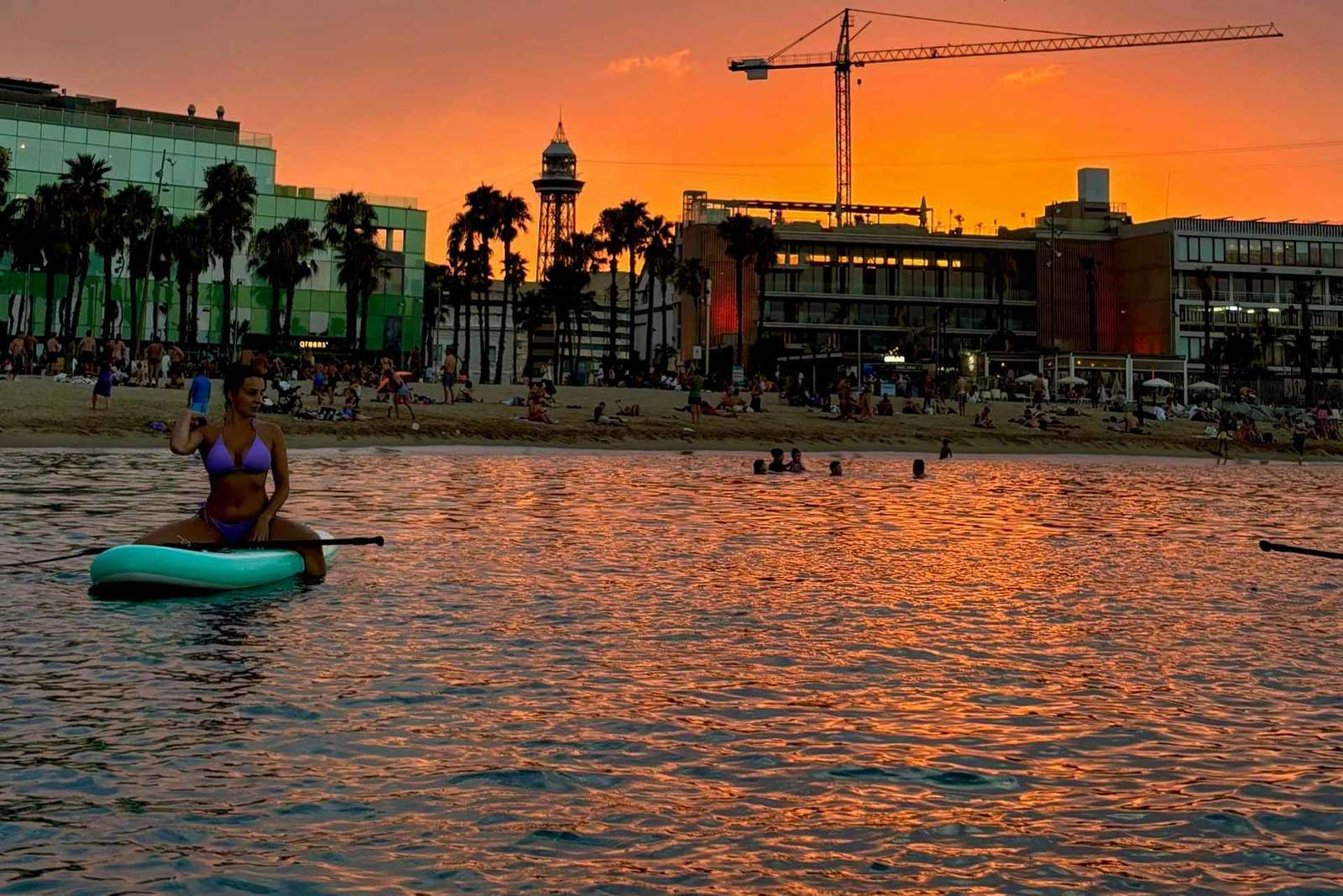 Paddleboarden bij zonsondergang langs de kust van Barcelona
